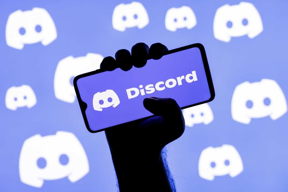 Holding Phone With Discord Branding