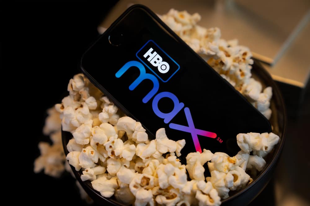 Phone Showing Hbo Max Logo Inside A Popcorn Cup.