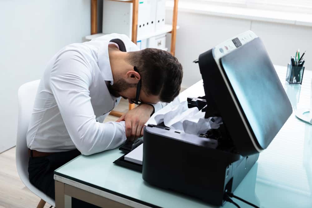 Frustrated Man Next To Printer