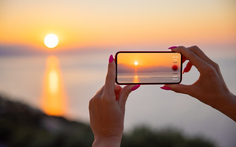 Iphone Taking Panorama Photo Of Sunset.