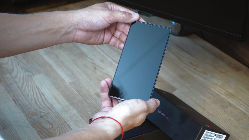 Man holding Android Phone that is turned off