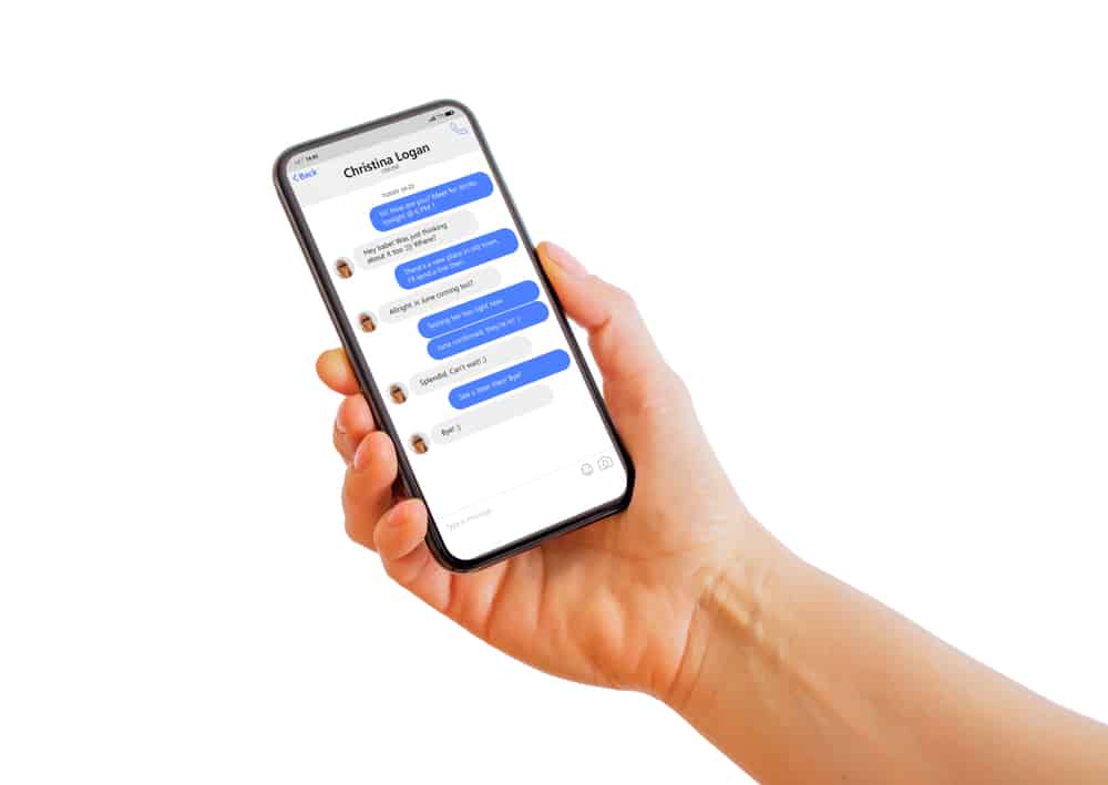 Man holding iPhone with message chat