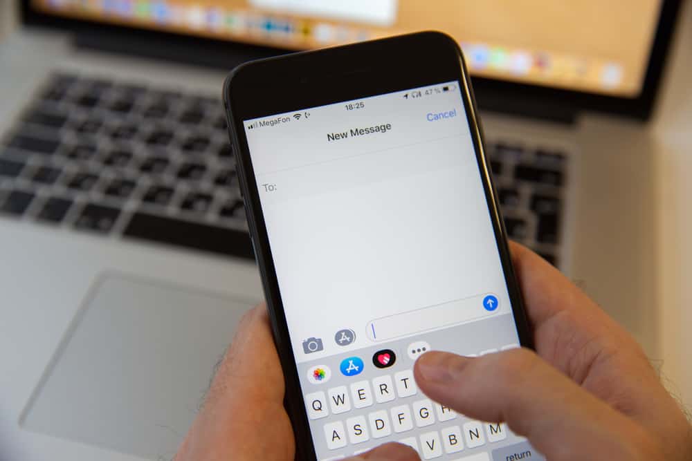  A person holding an iPhone with the keyboard open and the underline button highlighted.