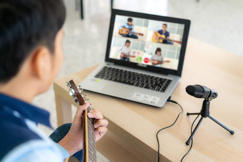 Guitar Playing In Front Of Laptop